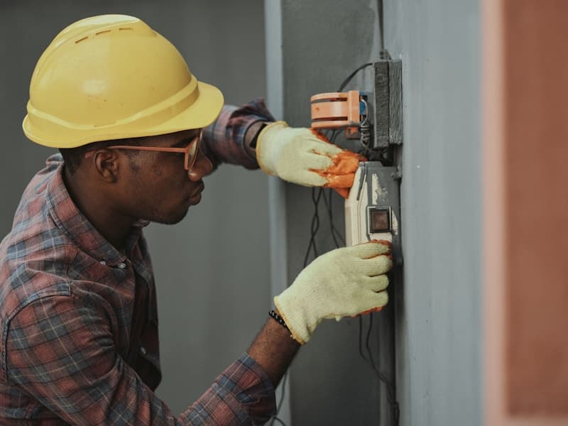 Licensed electrician working on electrical panel - journeyman electrician with NEC code knowledge