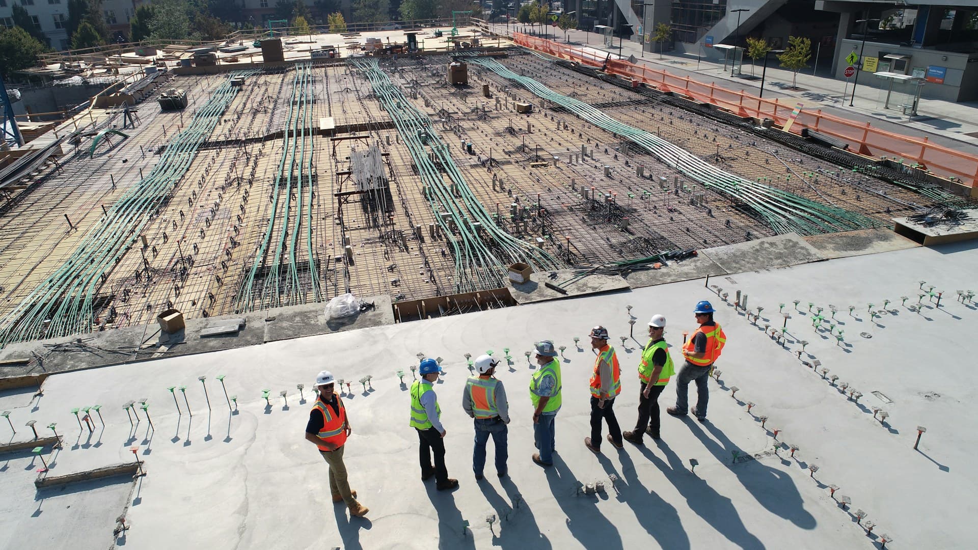 Construction site with skilled trades workers - HVAC, electrical, and plumbing contractors at work